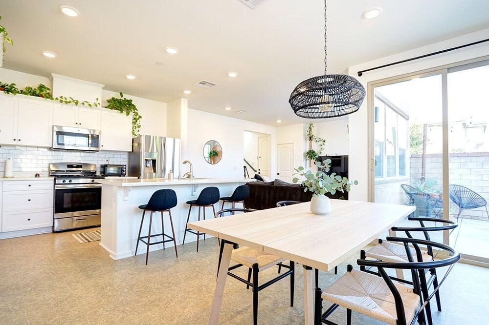 Modern open-concept kitchen with white cabinetry and a large center island in a Murrieta home.