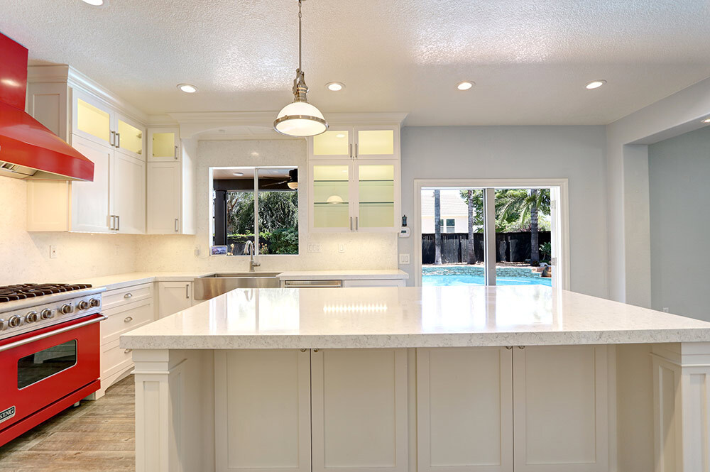 Upscale custom kitchen featuring professional-grade appliances and a white marble countertop in Riverside.