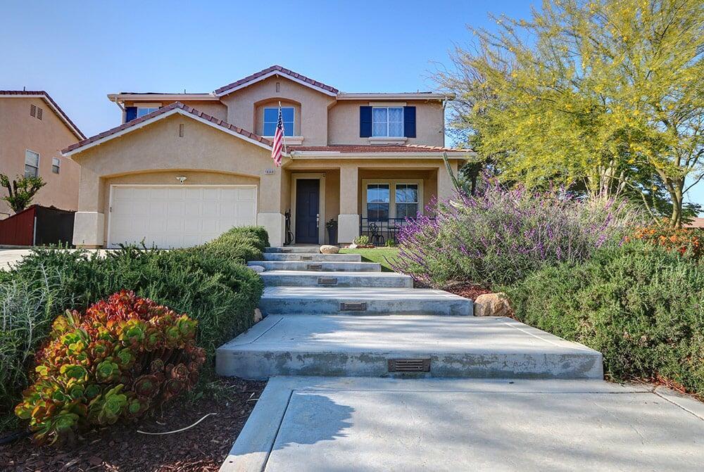 Contemporary house exterior with a paved walkway and desert-style landscaping for sale in Riverside.