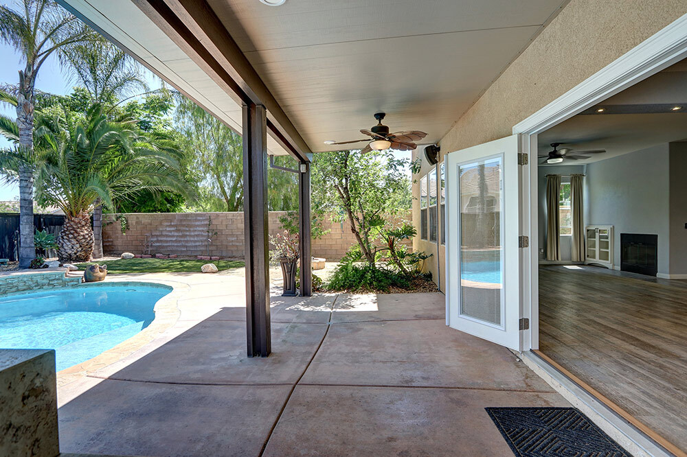 Backyard oasis featuring a crystal clear swimming pool and outdoor patio area in Riverside, California