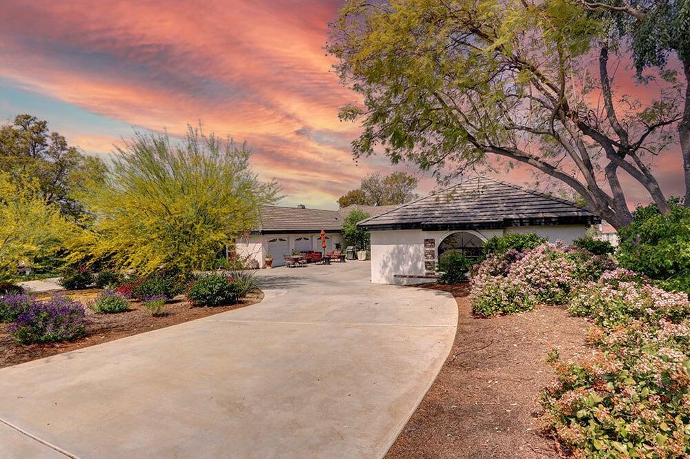 Large residential driveway leading to a spacious six-car garage at a luxury Riverside property.
